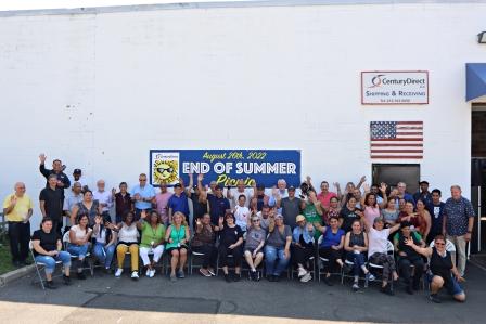 Group of employees gathered outside Century Direct for an "End of Summer Picnic" event, posing and waving for a group photo.