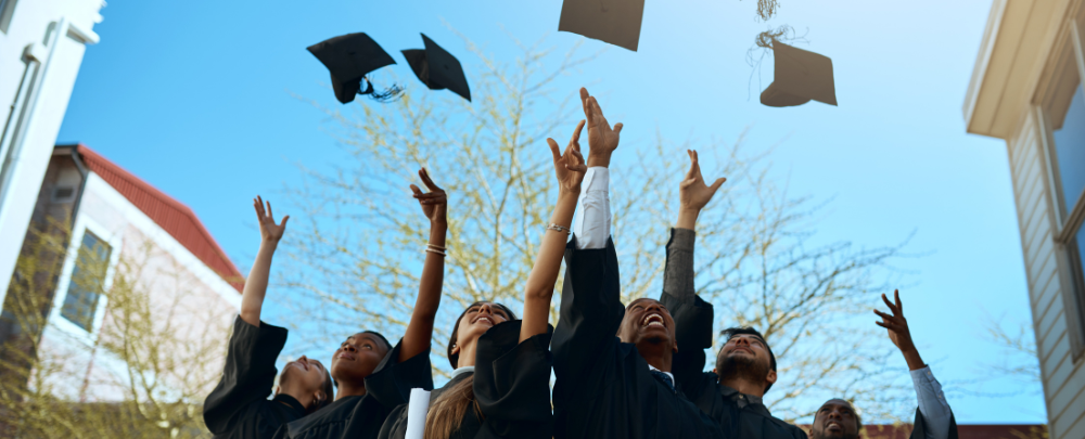 college graduates throwing cap